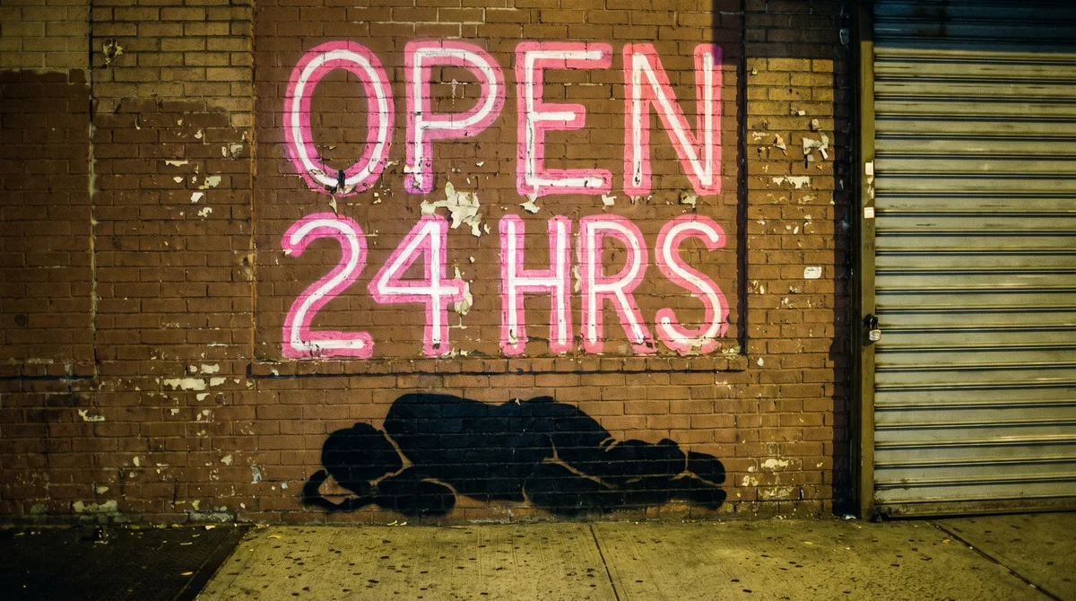 Open 24 Hrs, 2013. Neon letters over a man sleeping on the street. The city buffed it within a week.